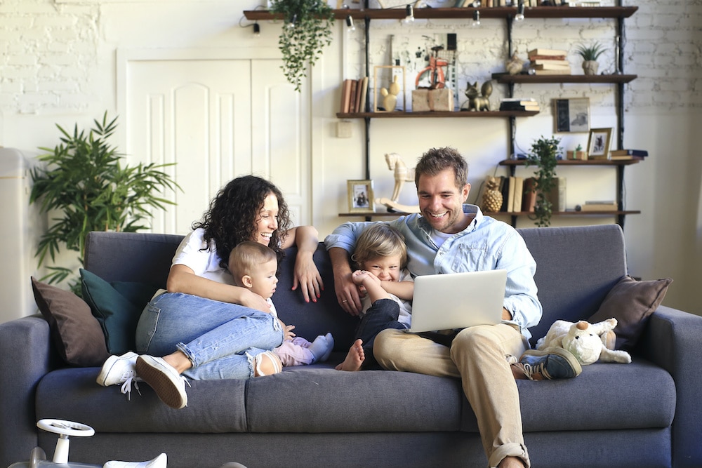 Family Sitting on Couch in Clean Air After an Air Duct Cleaning in Vienna, VA