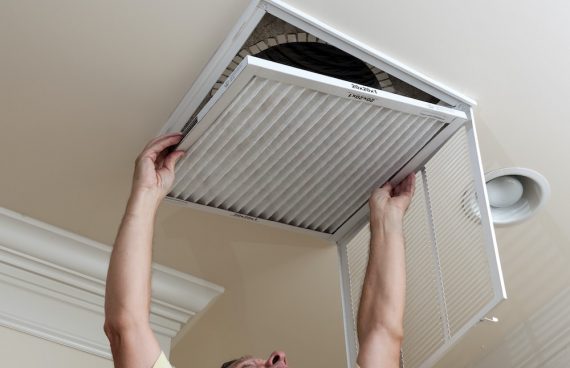 Air Duct Cleaning in Bethesda, MD man Cleaning the Vent