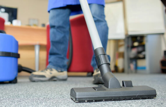 worker vacuuming carpet while providing Commercial Carpet Cleaning Services in Gaithersburg, MD