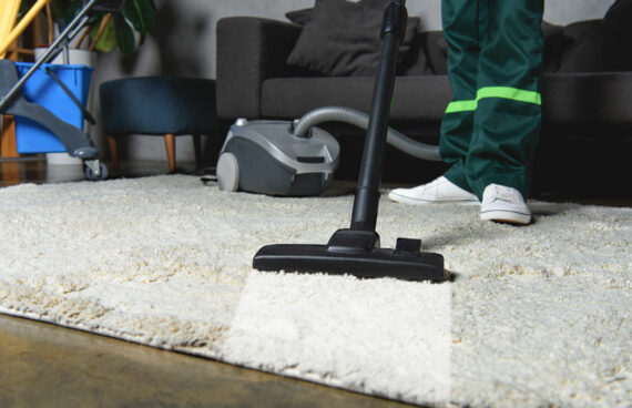 a worker with a vacuum performing Residential Carpet Cleaning Services in Ellicott City, MD