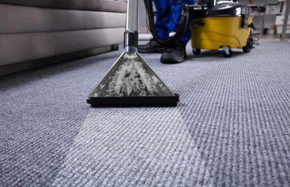 a worker using a vacuum providing Residential and Commercial Carpet Cleaning in Potomac