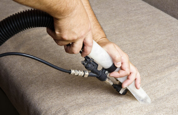 man with a vacuum performing Upholstery Stain Removal in Gaithersburg, Maryland