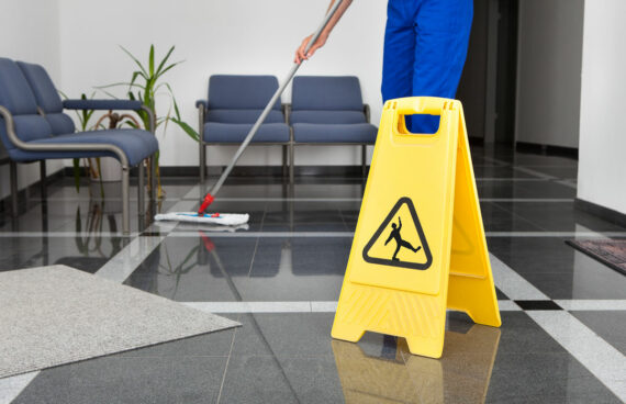 a worker cleaning the floor and providing Upholstery Cleaning and Commercial Carpet Cleaning in Ellicott City, MD