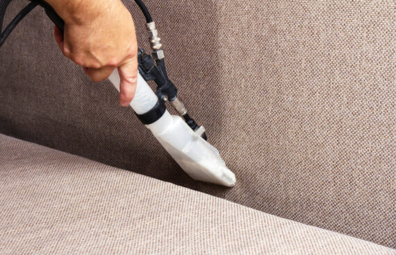 a worker using a vacuum to provide Upholstery Stain Removal in Leesburg, VA