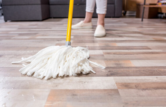 a woman with a mop performing Tile Cleaning for North Potomac Residents